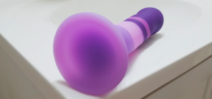 A close-up of the concave suction cup base of the Avant D2 Purple Rain Dildo.