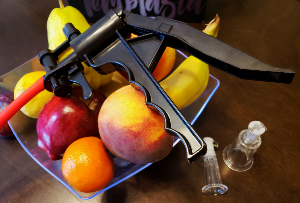 A close-up of the pump handle laying on top of the fruit bowl.