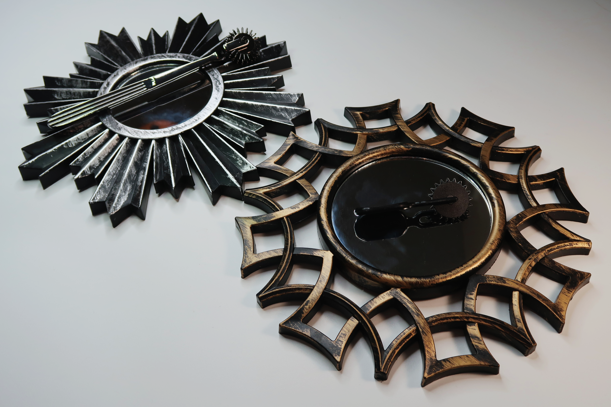 Two pinwheels laying on spike-edged mini mirrors.