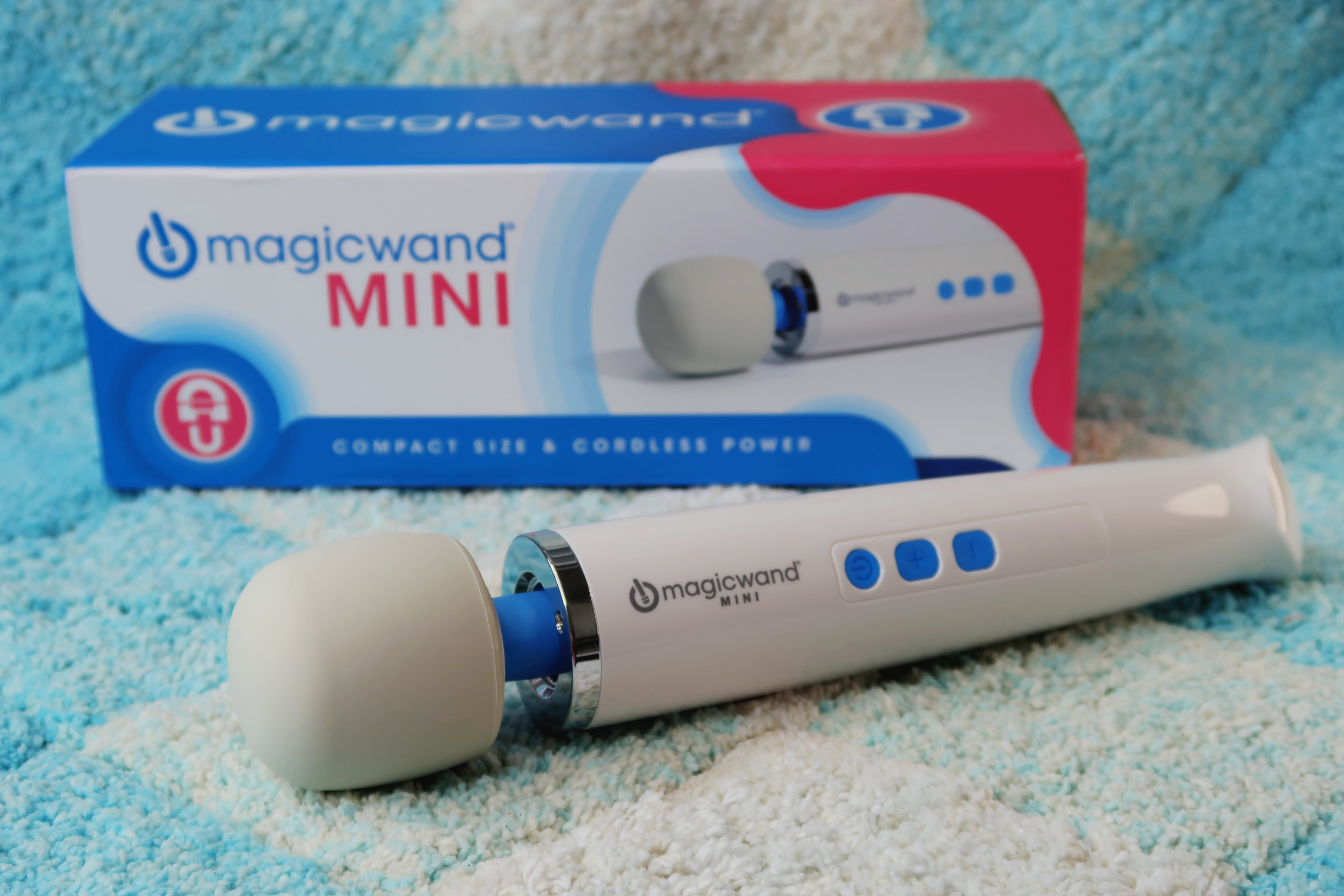 The Magic Wand Mini Original posed with its packaging.