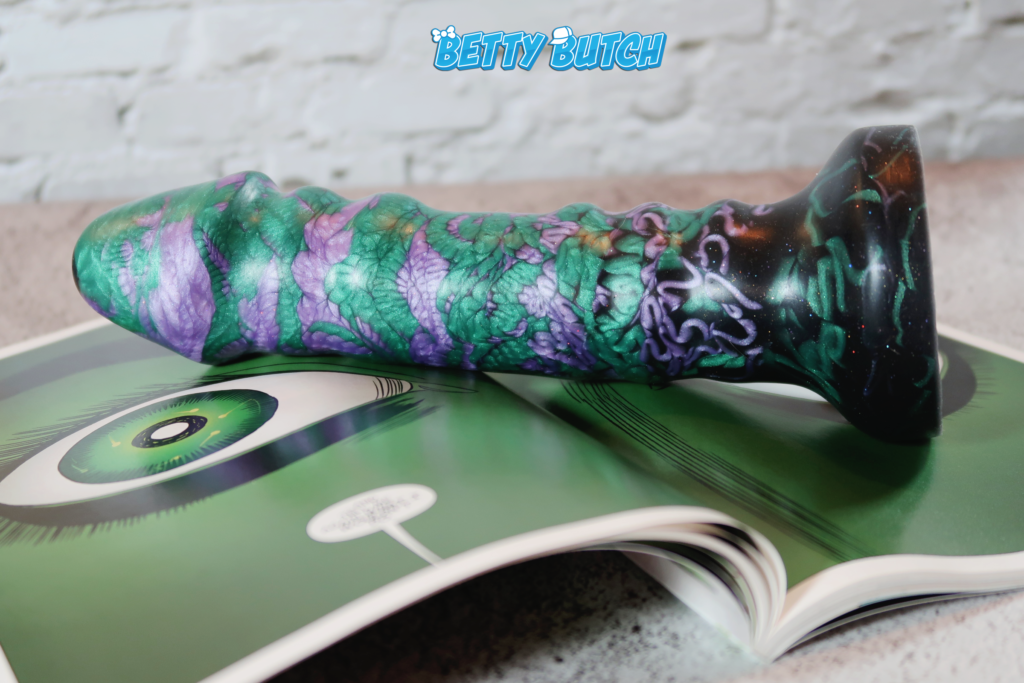 The Uberrime A-Spot Dildo pictured laying on its side on top of an open She-Hulk comic.