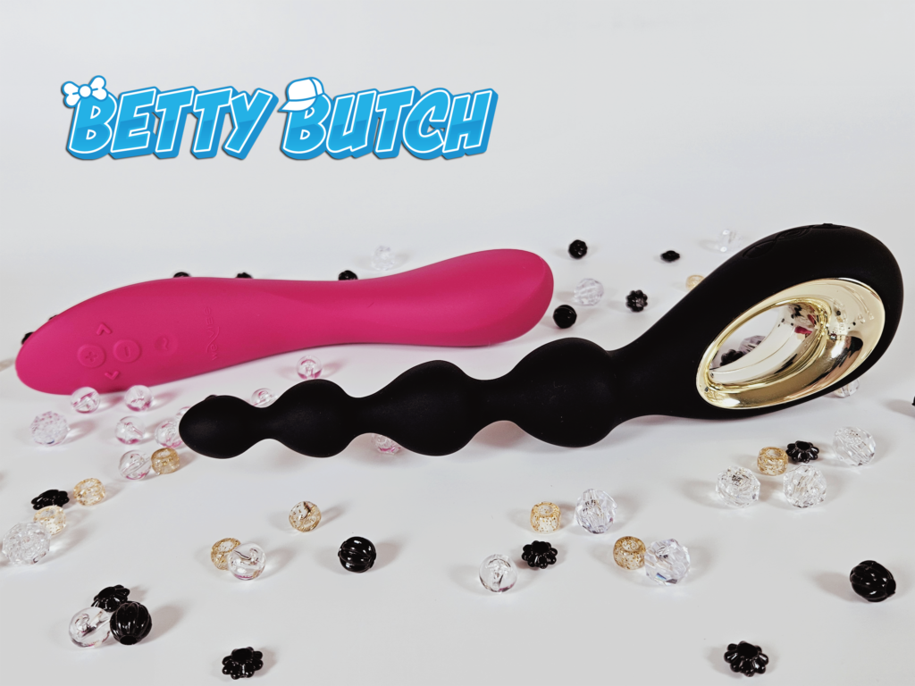 The Lelo Soraya Vibrating Anal Beads posed with the We-Vibe Rave 2 G-Spot vibrator, surrounded by scattered beads. 